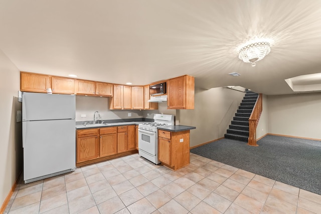 kitchen featuring sink, white appliances, and light colored carpet