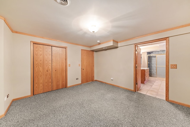 unfurnished bedroom with light carpet, ornamental molding, and a closet