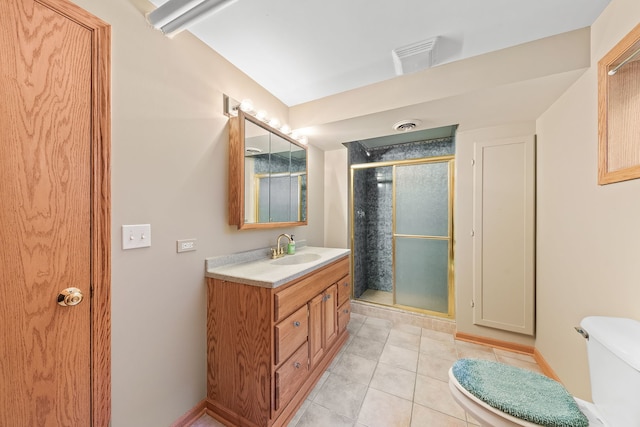 bathroom featuring tile patterned floors, vanity, toilet, and a shower with door