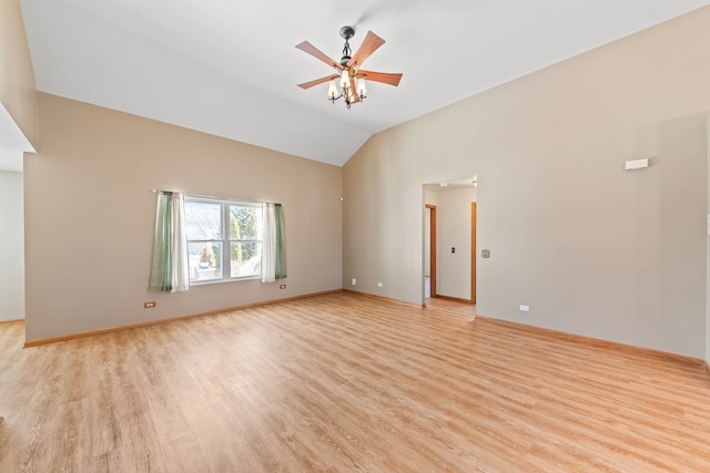 empty room with lofted ceiling, ceiling fan, and light wood-type flooring