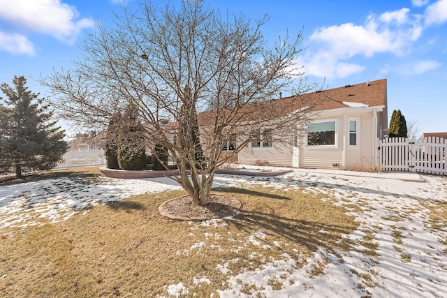 view of snow covered back of property