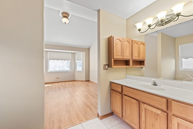 bathroom with vanity, a wealth of natural light, tile patterned floors, and an inviting chandelier