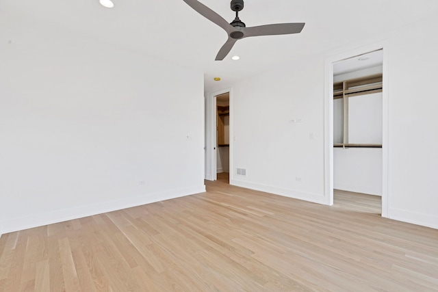 unfurnished bedroom featuring ceiling fan, a closet, and light wood-type flooring