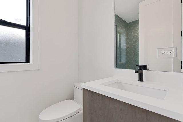 bathroom featuring toilet and vanity