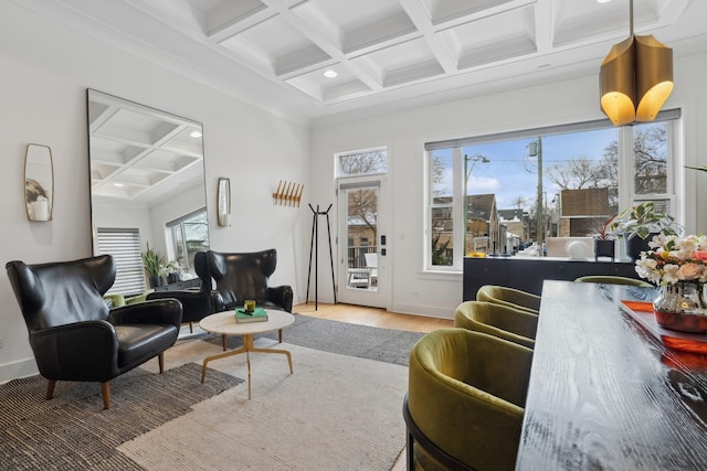 living room with hardwood / wood-style flooring, crown molding, beamed ceiling, and coffered ceiling