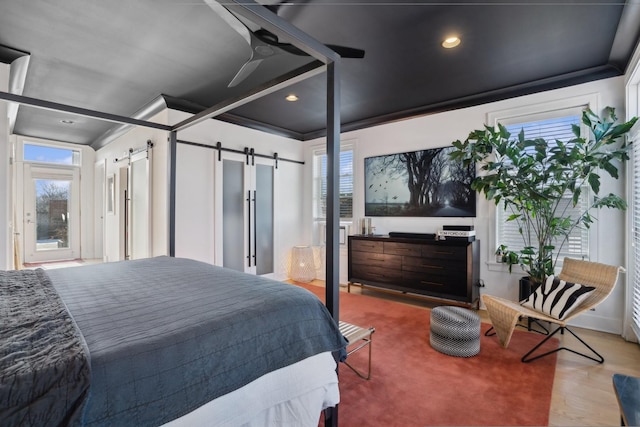 bedroom featuring a barn door and multiple windows