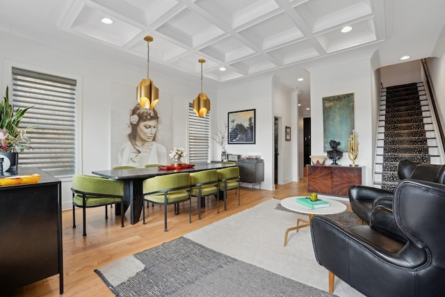 living room featuring beamed ceiling, ornamental molding, coffered ceiling, and light hardwood / wood-style flooring