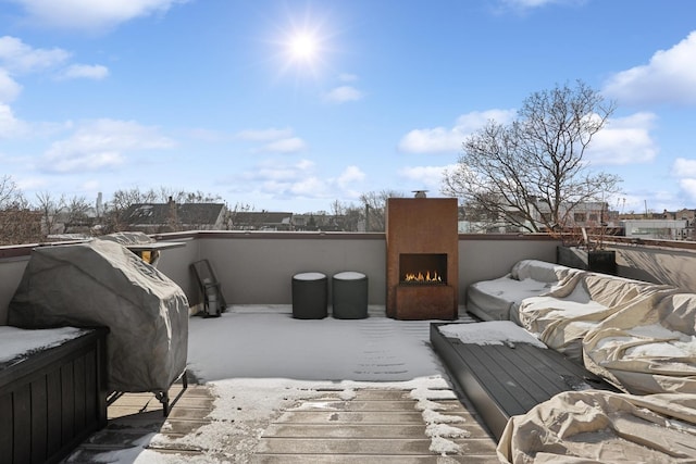 wooden deck with an outdoor fireplace