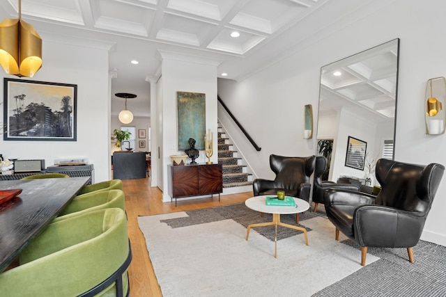 living room with wood-type flooring, ornamental molding, beam ceiling, and coffered ceiling