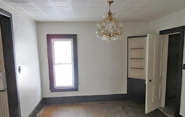 285 Fulton Pl, Canton, IL 61520 - unfurnished room with a chandelier and hardwood / wood-style flooring