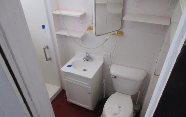 bathroom featuring toilet and vanity