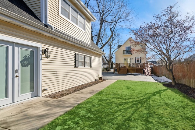 view of yard with a wooden deck and a patio area