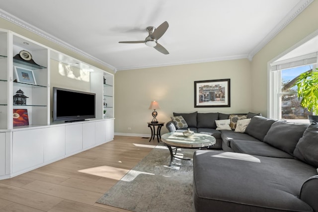 living room featuring ornamental molding, ceiling fan, light hardwood / wood-style floors, and built in shelves