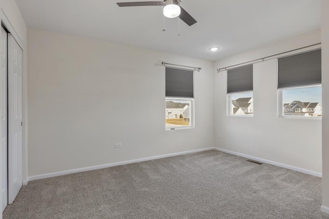 unfurnished bedroom with ceiling fan, carpet floors, and a closet