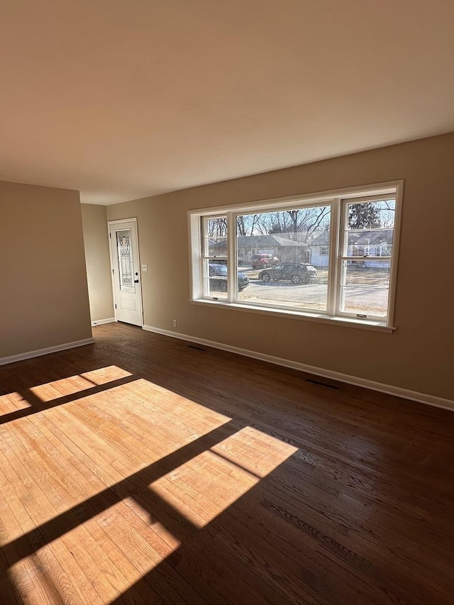 spare room with dark wood-type flooring