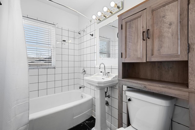 bathroom featuring toilet, tile patterned flooring, and shower / tub combo with curtain