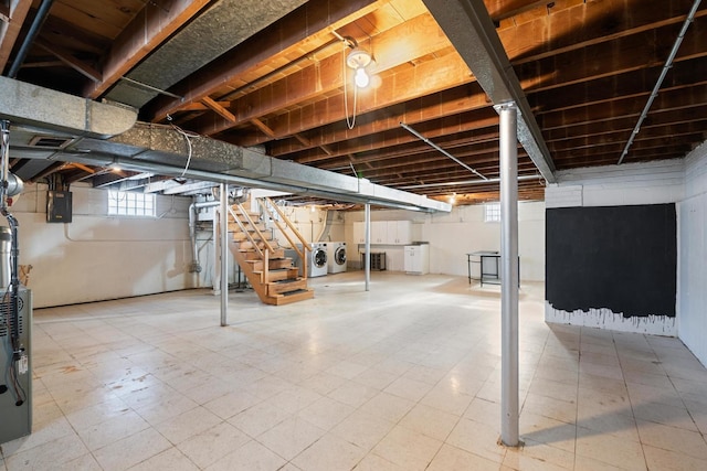 basement with washer and clothes dryer and electric panel