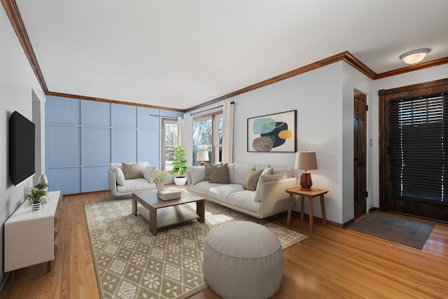 living room with crown molding and light wood-type flooring