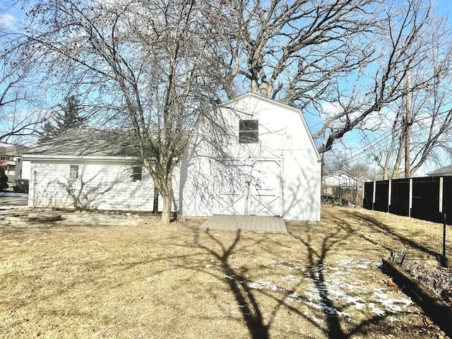 view of side of home with a shed and a yard