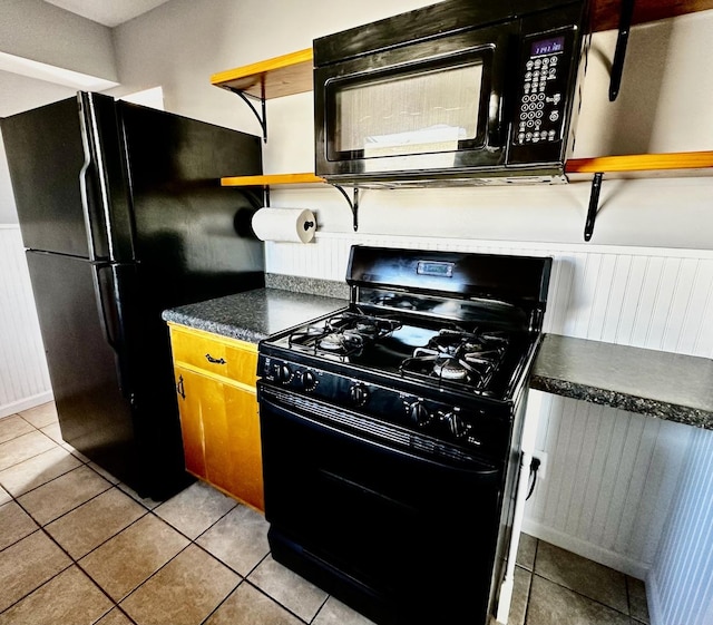 kitchen with light tile patterned floors and black appliances