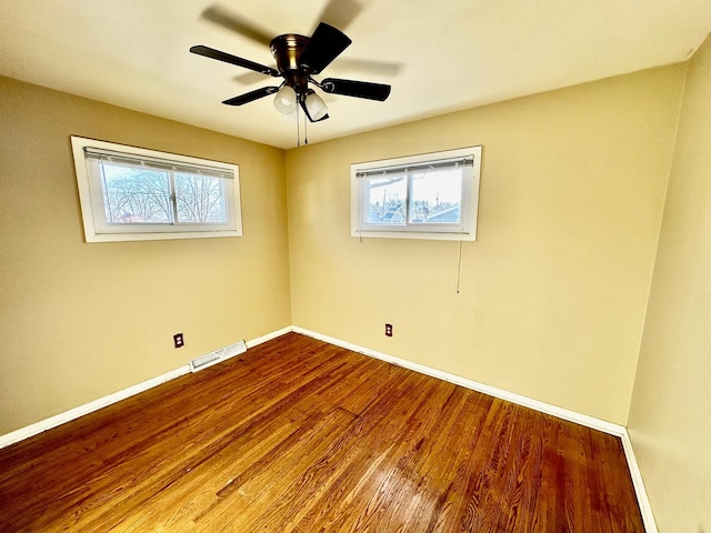 spare room featuring hardwood / wood-style flooring and ceiling fan