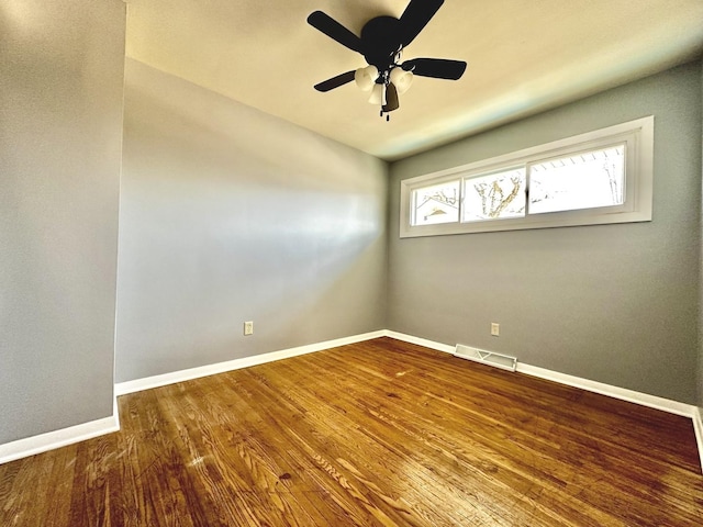 empty room with ceiling fan and wood-type flooring