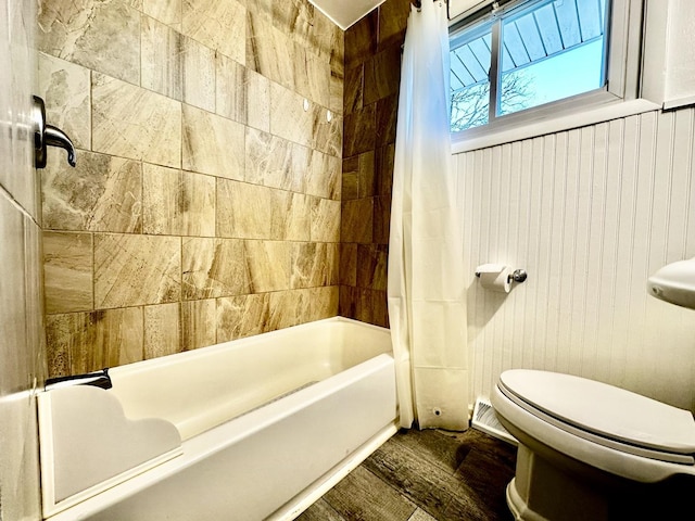 bathroom featuring toilet, shower / tub combo, and wood-type flooring