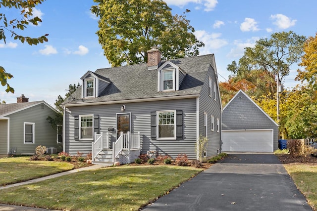 cape cod home featuring a garage, a front yard, and an outdoor structure