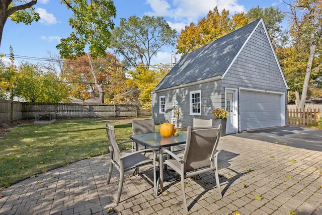 view of patio / terrace with a garage and an outdoor structure