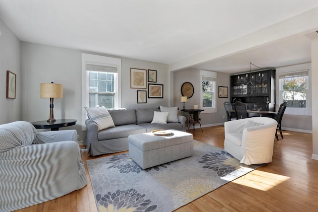 living room featuring an inviting chandelier and hardwood / wood-style flooring