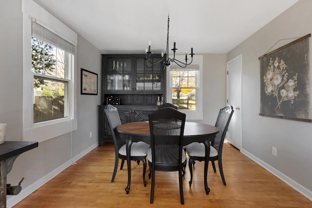 dining space featuring an inviting chandelier and hardwood / wood-style floors