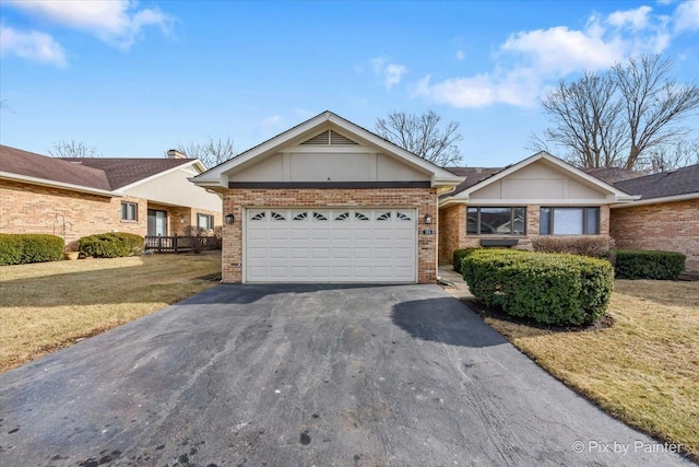 single story home featuring a garage and a front lawn