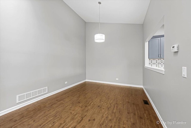 spare room with dark hardwood / wood-style floors