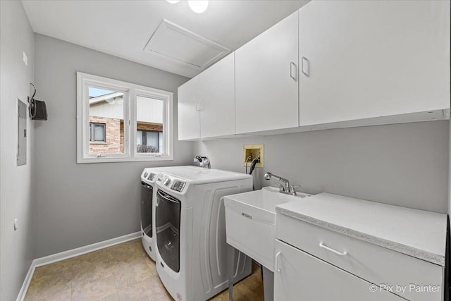 laundry area featuring sink, cabinets, and washing machine and clothes dryer