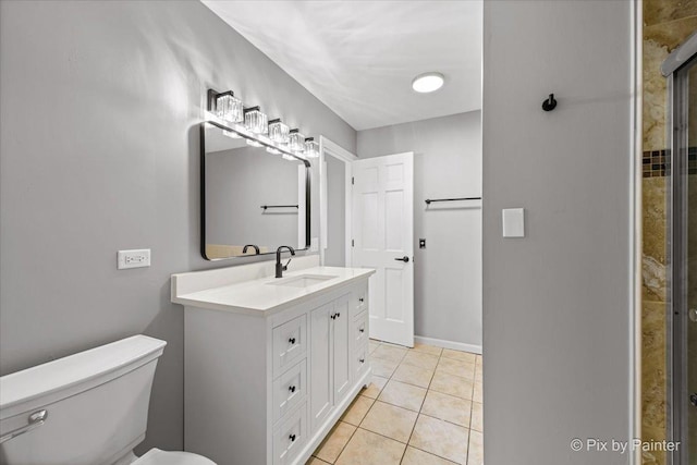 bathroom featuring vanity, tile patterned floors, and toilet