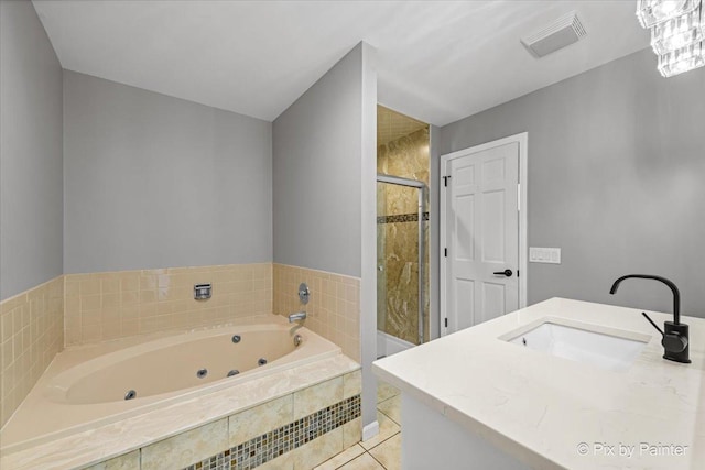 bathroom with shower with separate bathtub and vanity