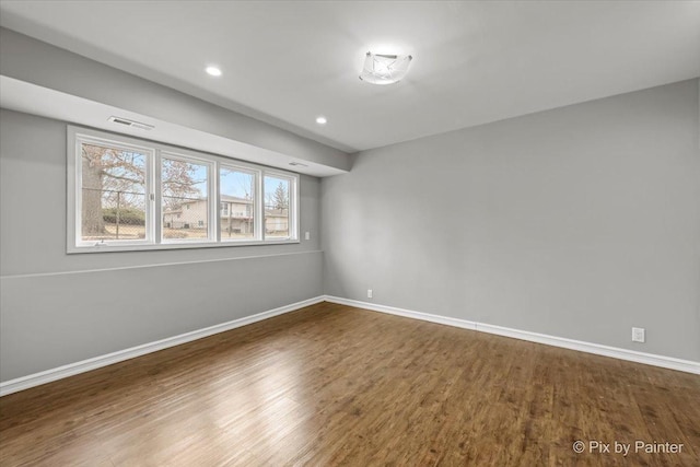 spare room featuring wood-type flooring