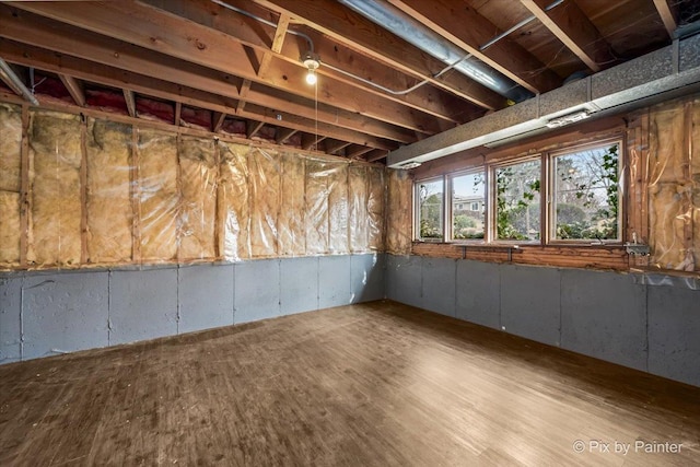 basement with hardwood / wood-style flooring