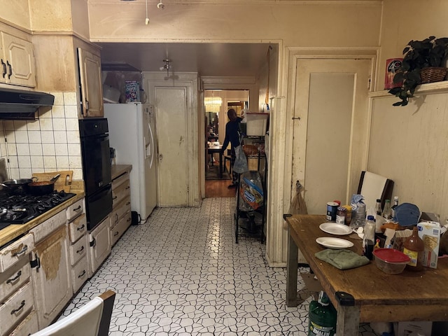 kitchen featuring white fridge with ice dispenser and black gas cooktop