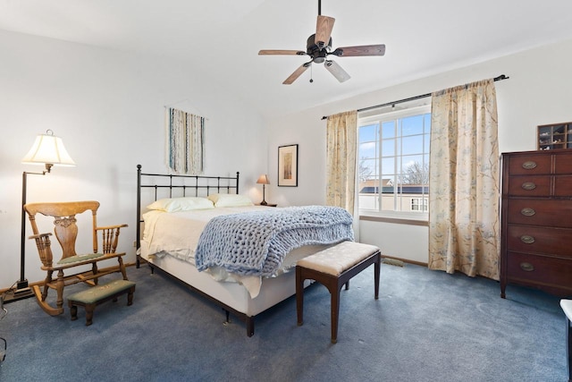 bedroom with carpet flooring, vaulted ceiling, and ceiling fan