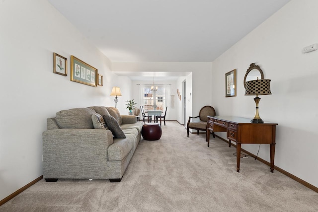 living area featuring carpet floors, an inviting chandelier, and baseboards