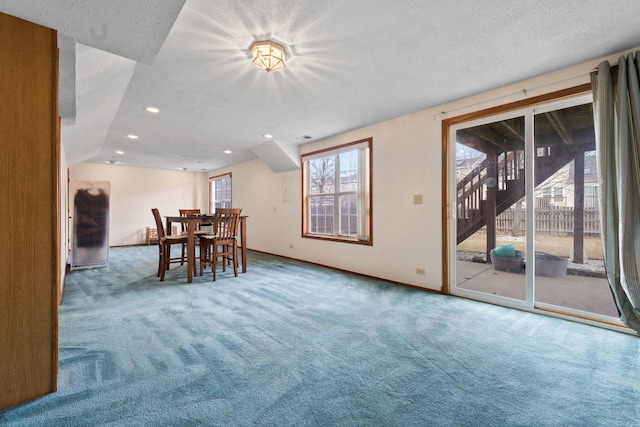 unfurnished dining area featuring a textured ceiling, carpet, baseboards, and recessed lighting