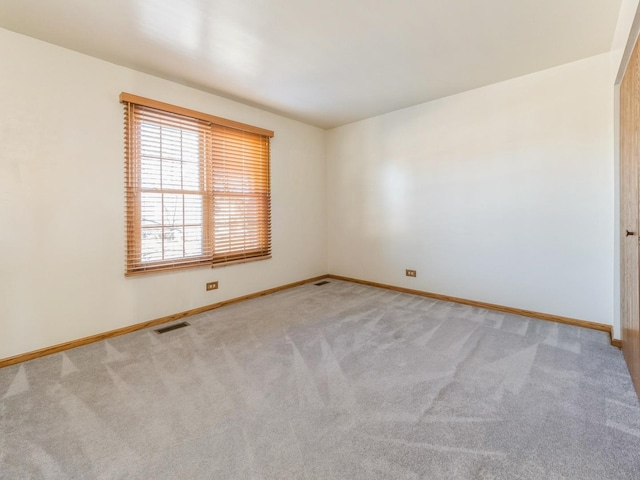 unfurnished room with light carpet