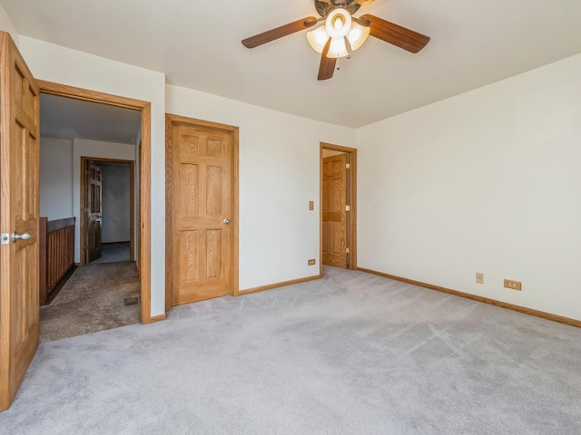 unfurnished bedroom featuring ceiling fan and light colored carpet