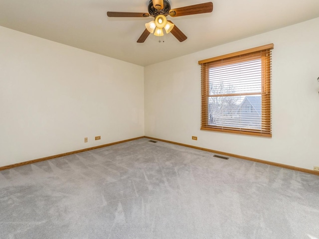 unfurnished room featuring ceiling fan and light carpet