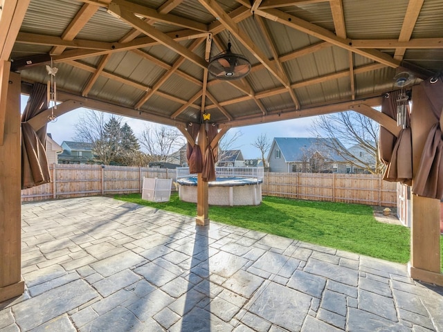 view of patio / terrace with a fenced in pool, a gazebo, and ceiling fan