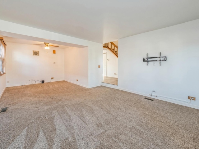 carpeted spare room with ceiling fan