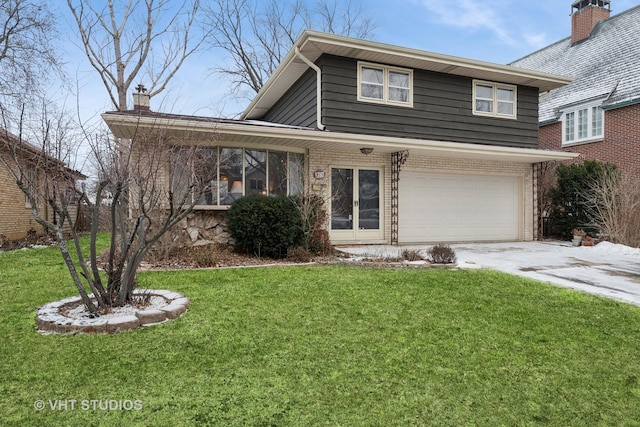 view of front of home featuring a garage and a front lawn