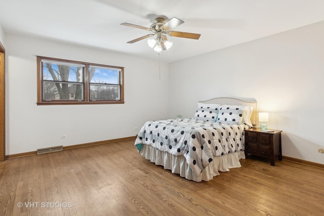 bedroom with wood-type flooring and ceiling fan