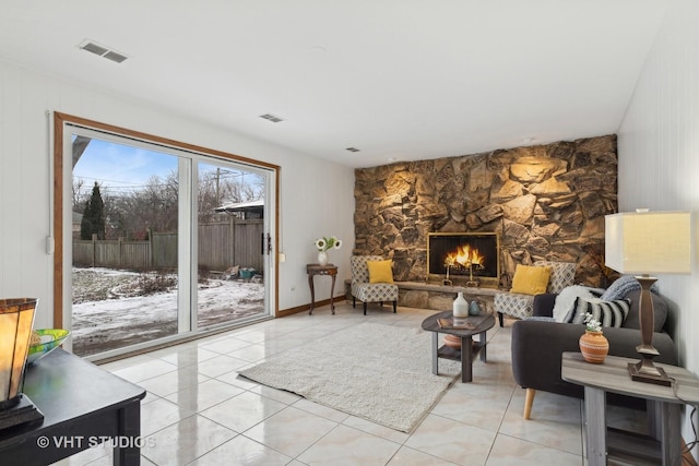 living room featuring a fireplace and light tile patterned floors